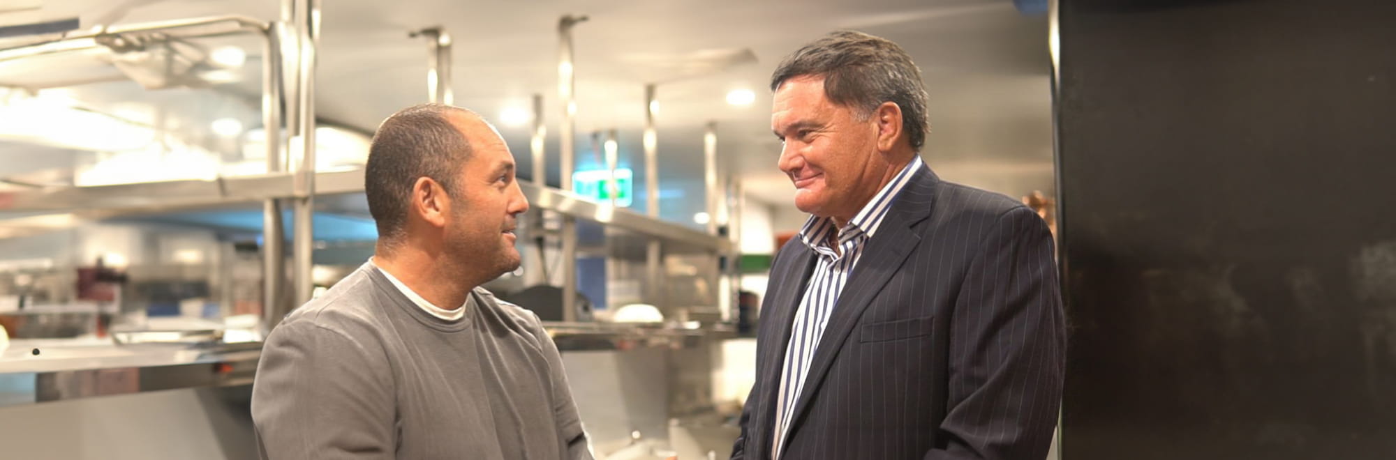 L-R: Chef Guillaume Brahimi and Aurecon Chair Giam Swiegers discuss business leadership in restaurant kitchen.