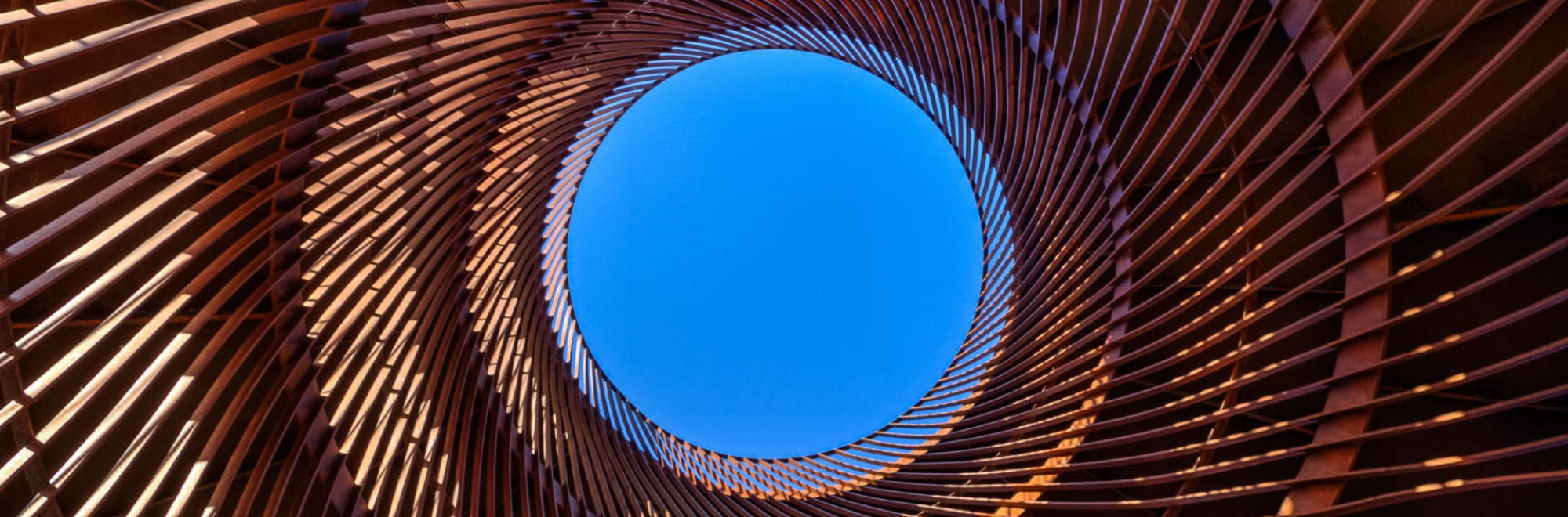 Blue sky and circular metal structure. Presenter images overlayed: Carsten Dethlefsen, Wayne Hubbard, Jodie Bricout.