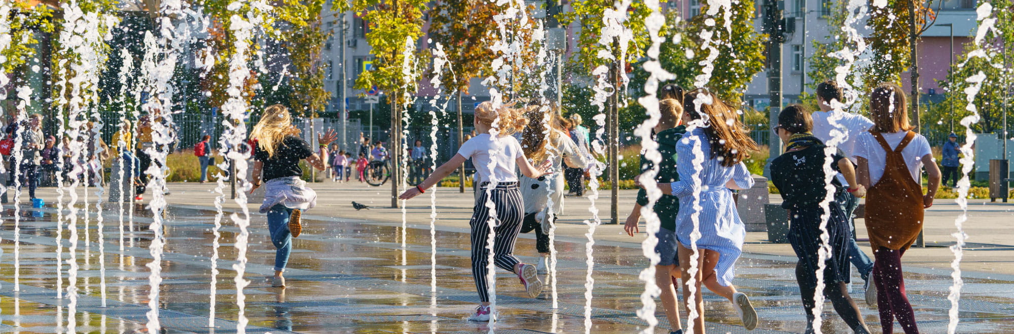 Children funning through city water feature. Presenter images overlayed: Tiffany Crawford, Krista Milne, Michael Nolan.