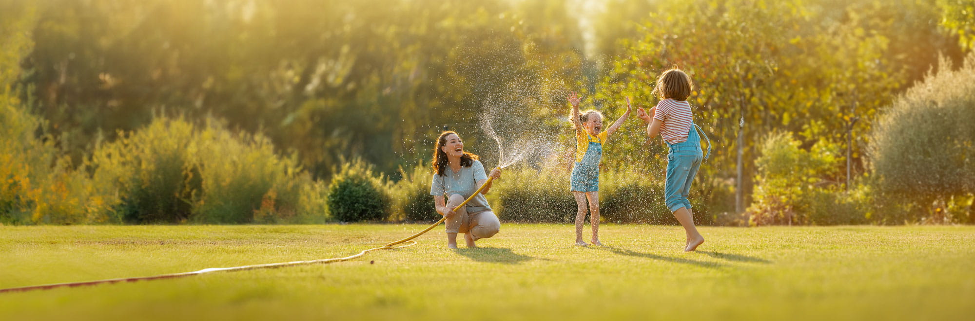 Woman and two children playing with hose in garden. Presenter images overlayed, order top to bottom: Andrew Salveson, Ryan Signor.